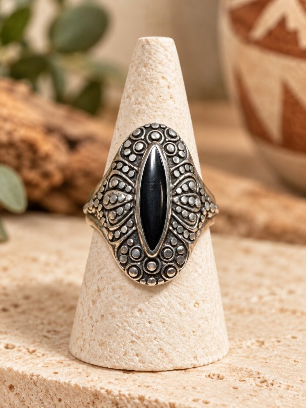 Vintage sterling silver cocktail ring featuring a marquise-cut black onyx center